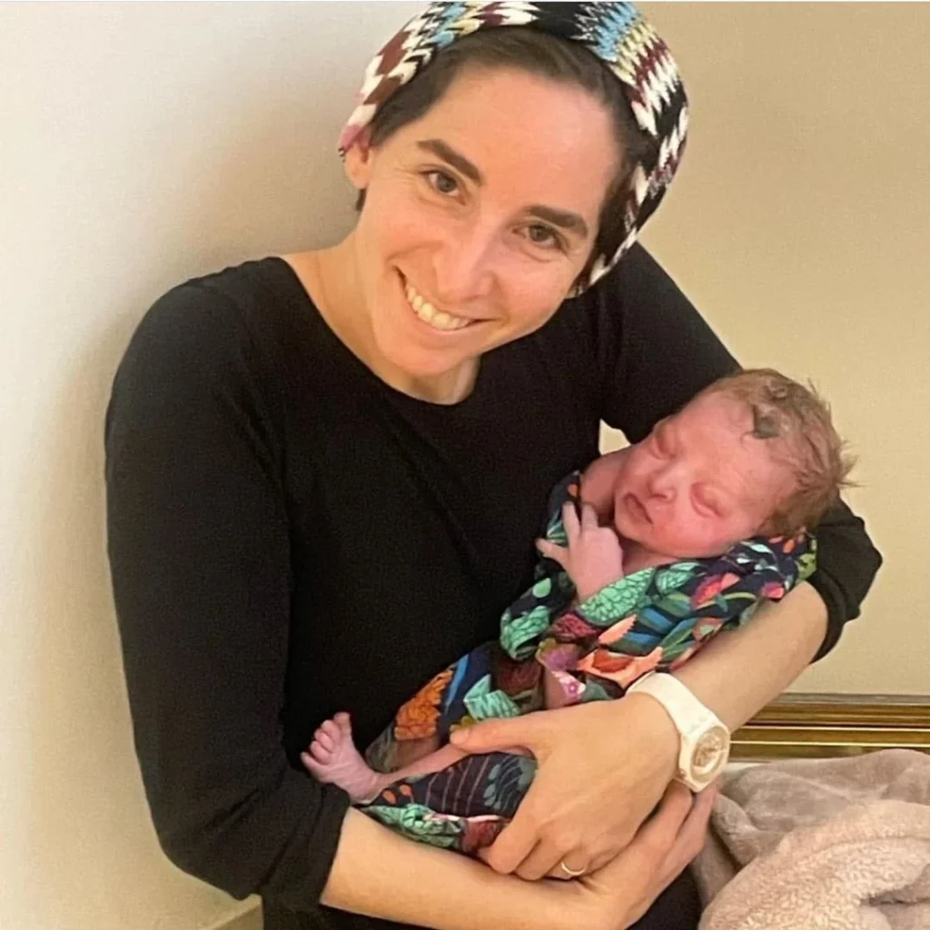Judy Ribner holding a newborn baby