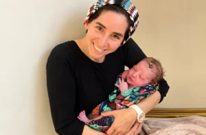 Judy Ribner holding a baby