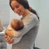 Judy Ribner Holding a baby